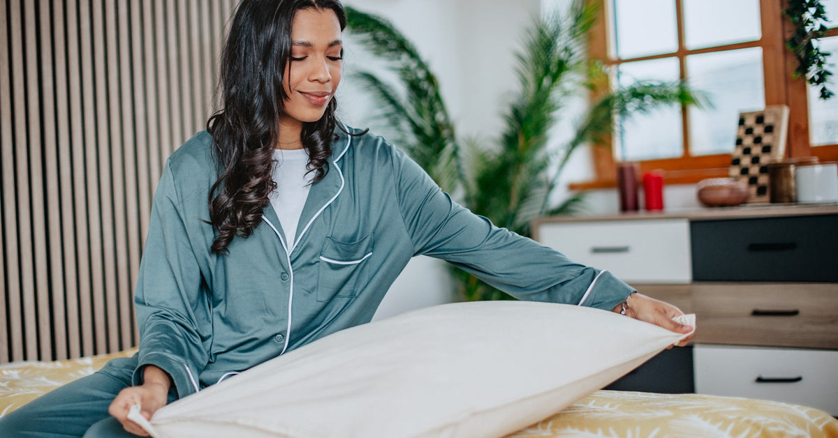 Woman inspecting a white pillowcase before making her choice