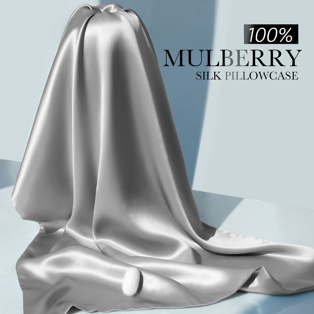 Draped silver-grey mulberry silk fabric showcasing its smooth, lustrous texture.