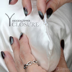 Hands opening hidden zipper on ivory white silk pillowcase — keeps pillow secure all night.