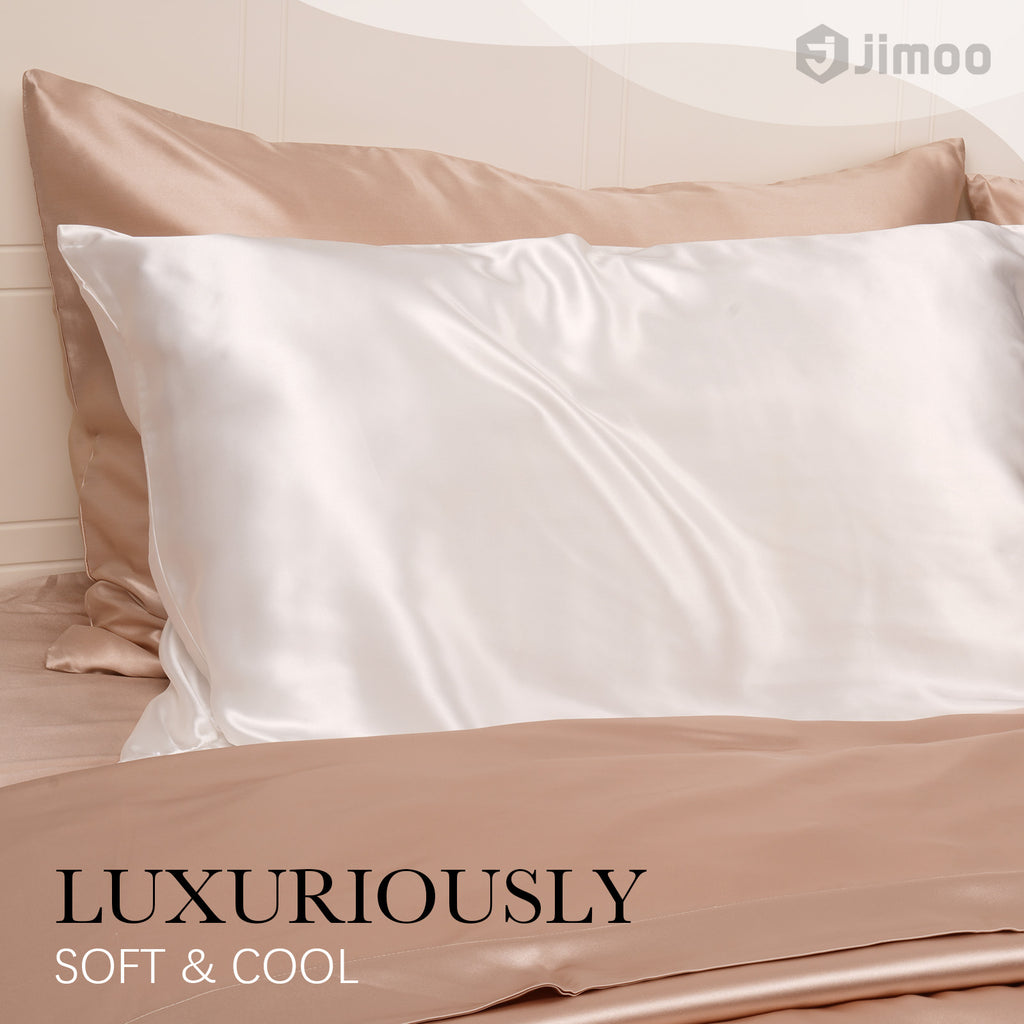 Ivory white silk pillowcase on a champagne bed — luxuriously soft and cool to the touch.