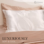 Ivory white silk pillowcase on a champagne bed — luxuriously soft and cool to the touch.
