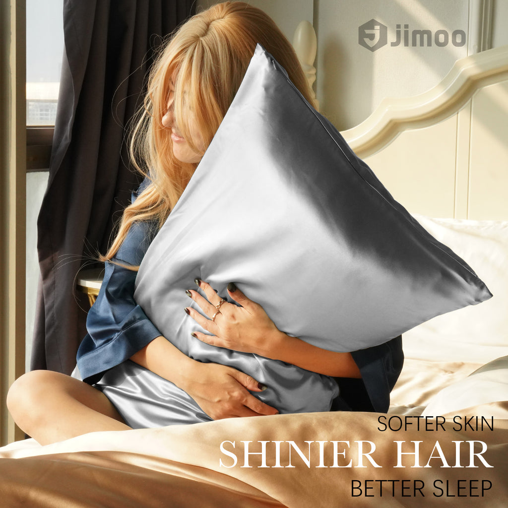 Woman hugging a silver-grey silk pillowcase — softer skin, shinier hair, better sleep.